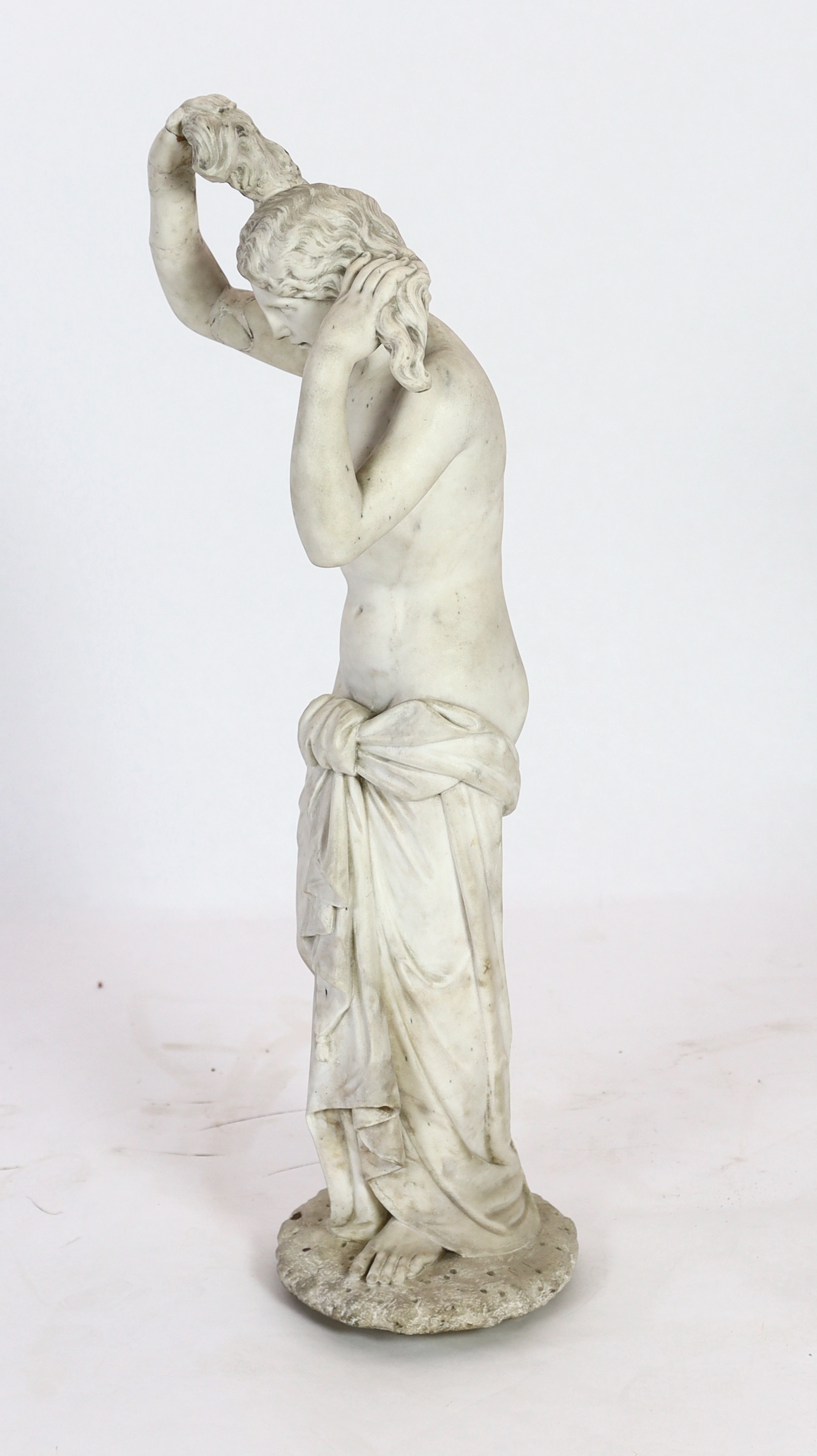 After the Antique. A late 19th century Italian carved white marble figure of Venus Anadyomene